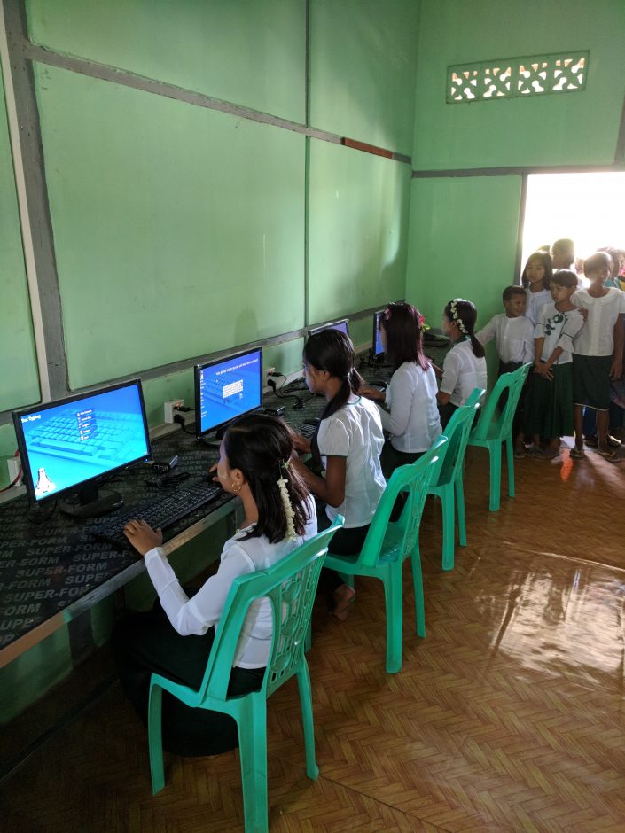 girls typing on computers